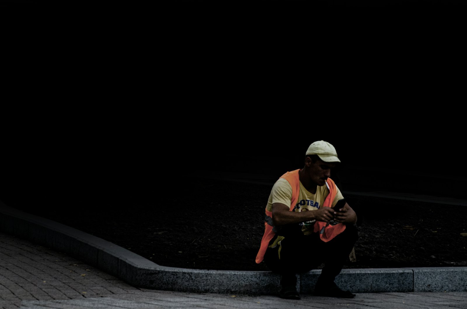 A lone worker in high-visibility clothing at night